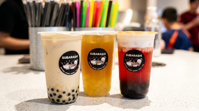 Three Subarashi bubble teas: milk tea with boba, yellow fruit tea, and red fruit tea.