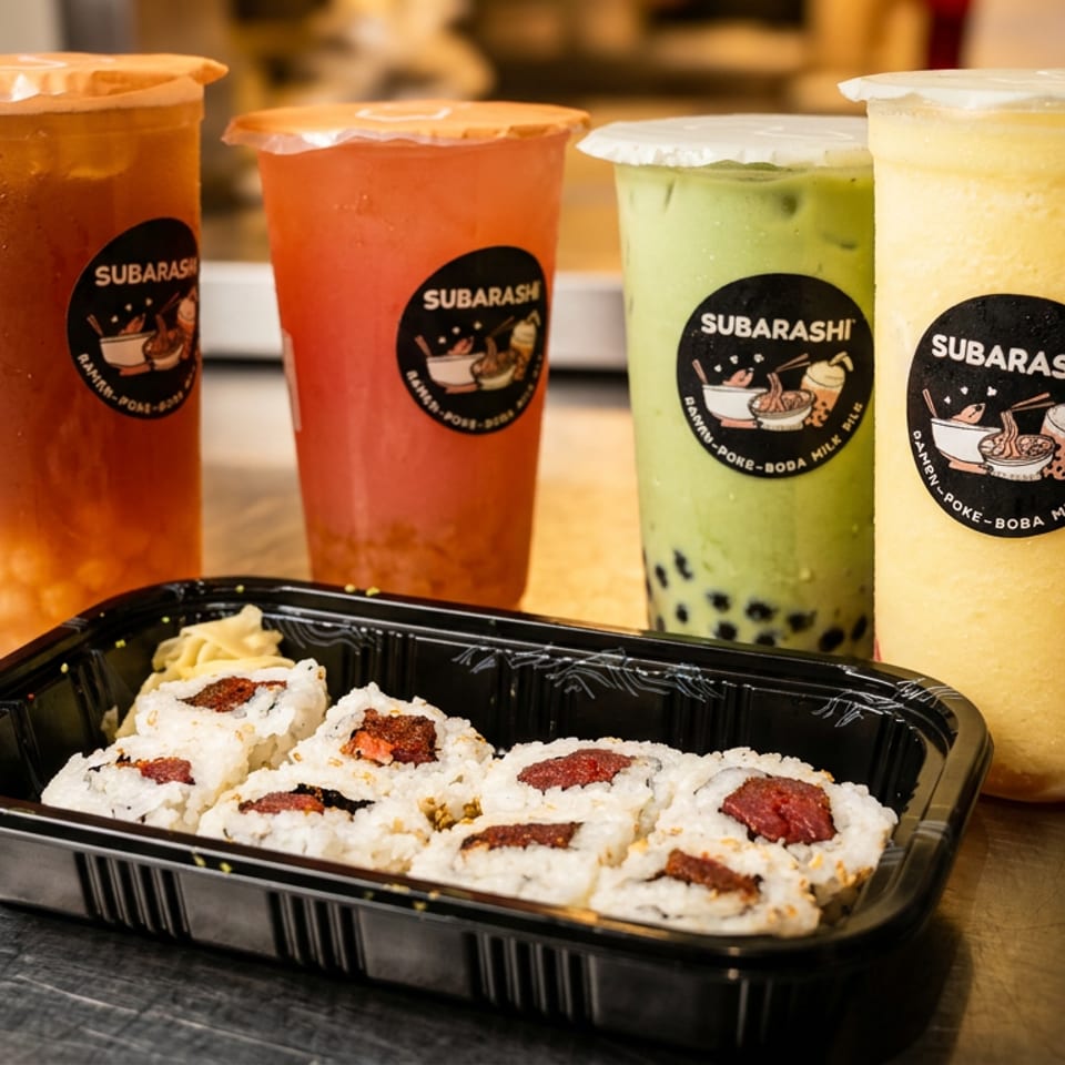Four colorful Subarashi branded drinks and a container of sushi rolls on a metal surface.